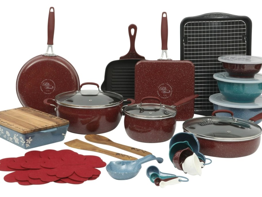 a set of red and black cookware with mixing bowls, wood kitchen utensils, mixing bowls and baking dishes on a countertop