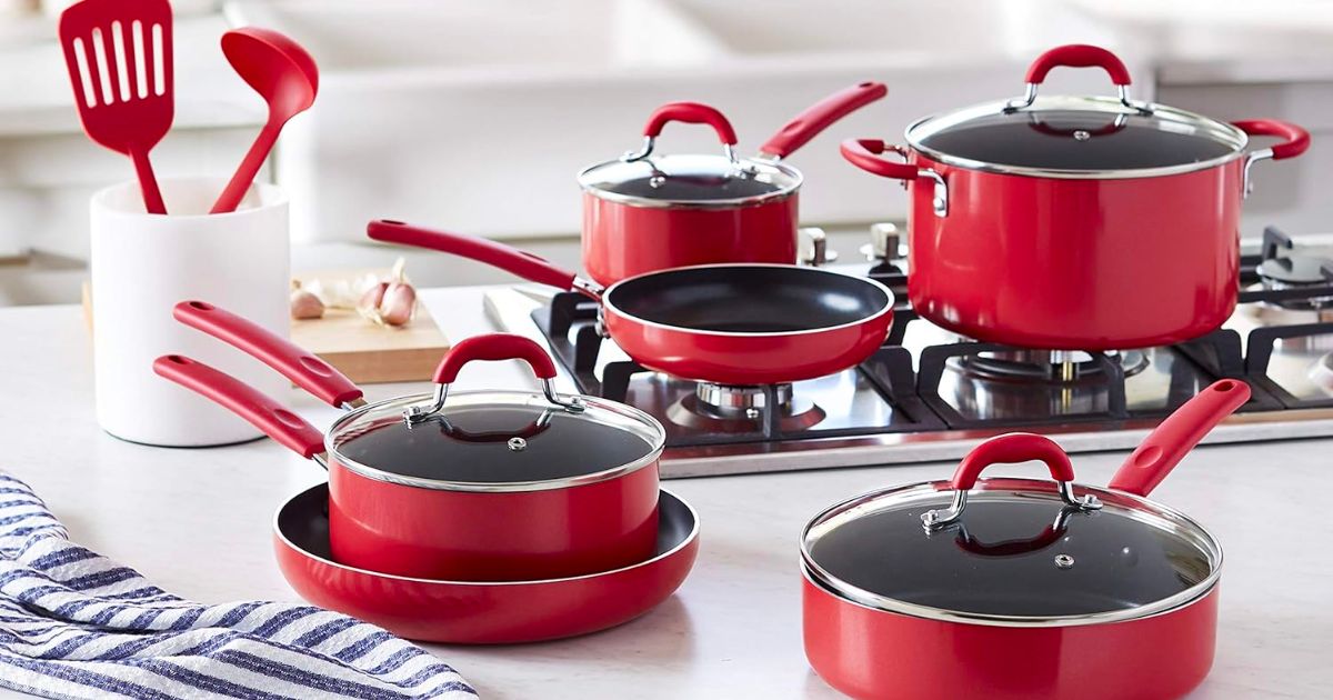 red cookware set on a stove in a kitchen