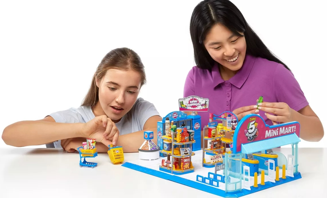 girls playing with a 5 Surprise Mini Brands Series 4 Mini Mart