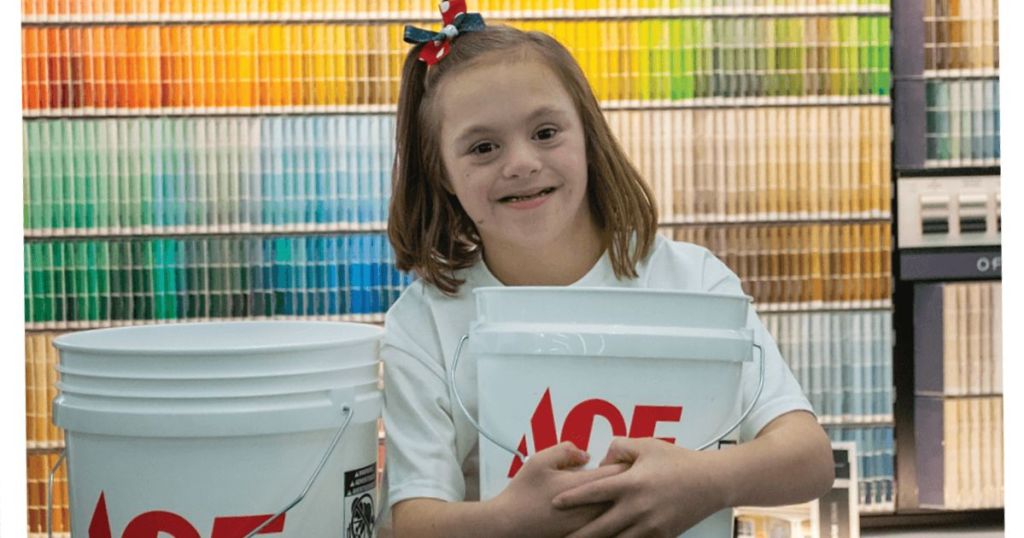A child hugging an Ace Hardware bucket