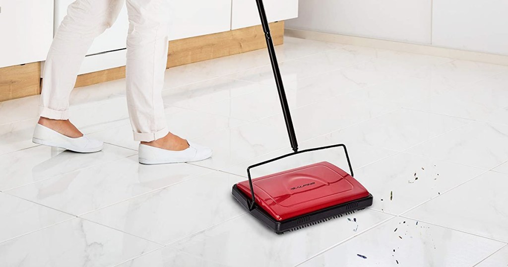 using red carpet sweeper on tile floor