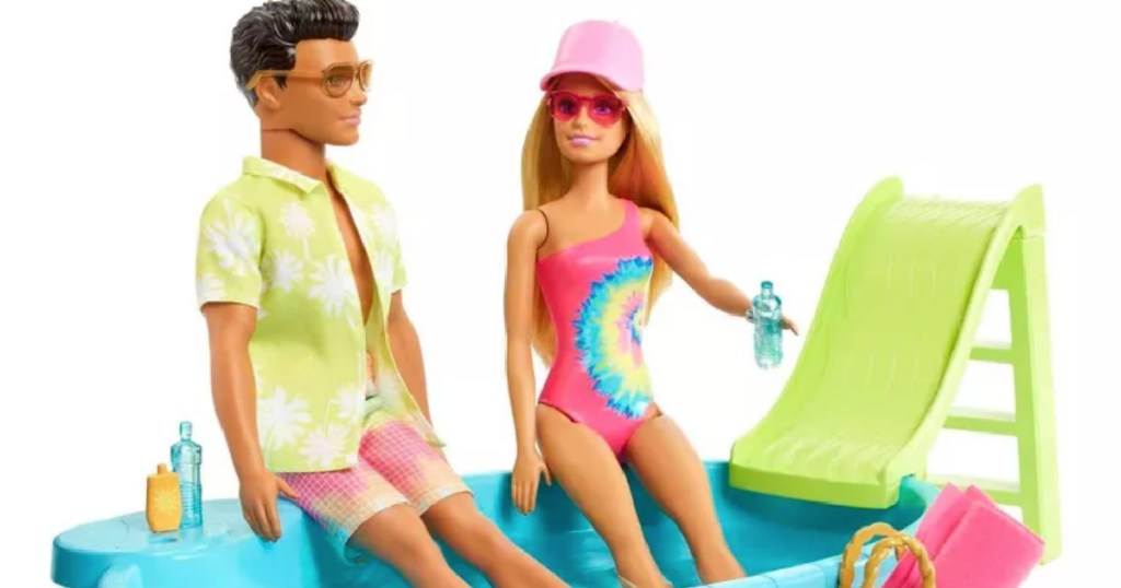 barbie dolls sitting on pool edge