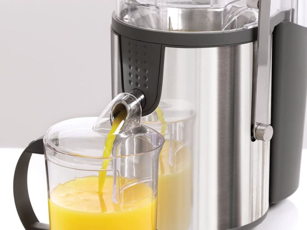 Bella juicer with orange juice coming out