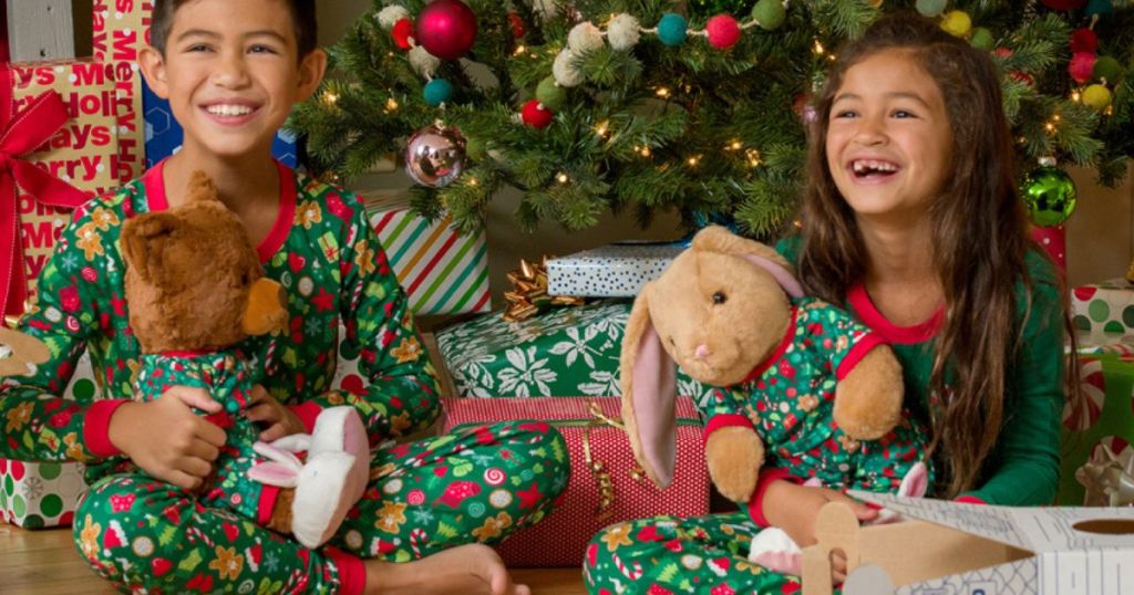 Kids with build a bear plush wearing matching pajamas