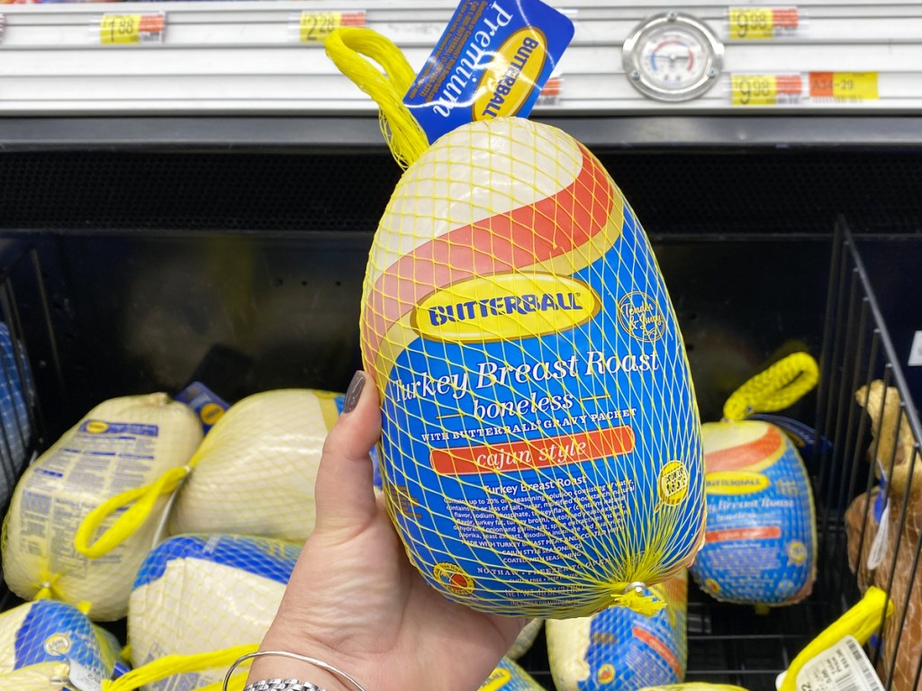 person holding up a butterball turkey roast in store