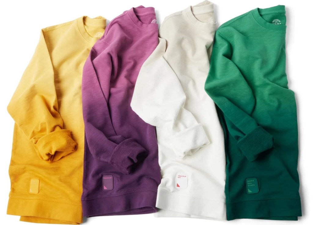 Row of ombre sweatshirts in yellow, purple, white, and green