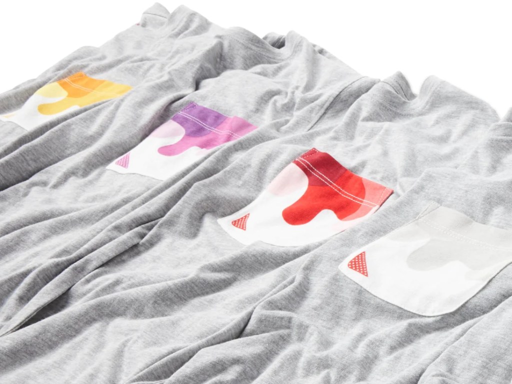 Row of grey shirts with colorful pockets