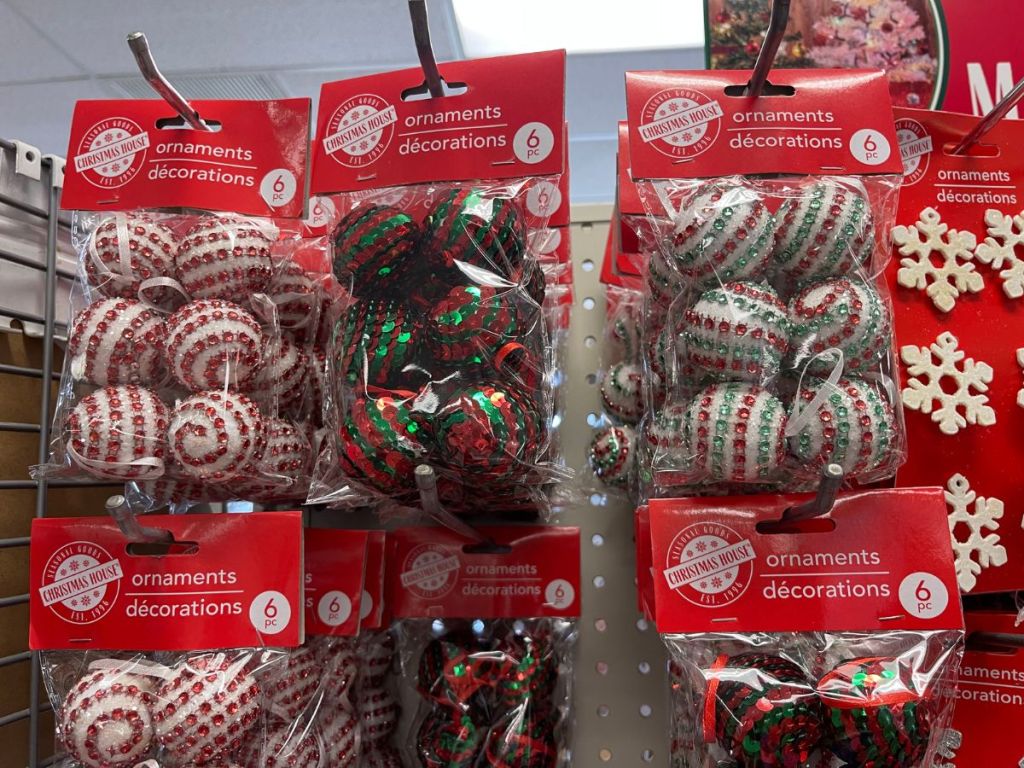 Red and white christmas ornaments on a shelf in a store