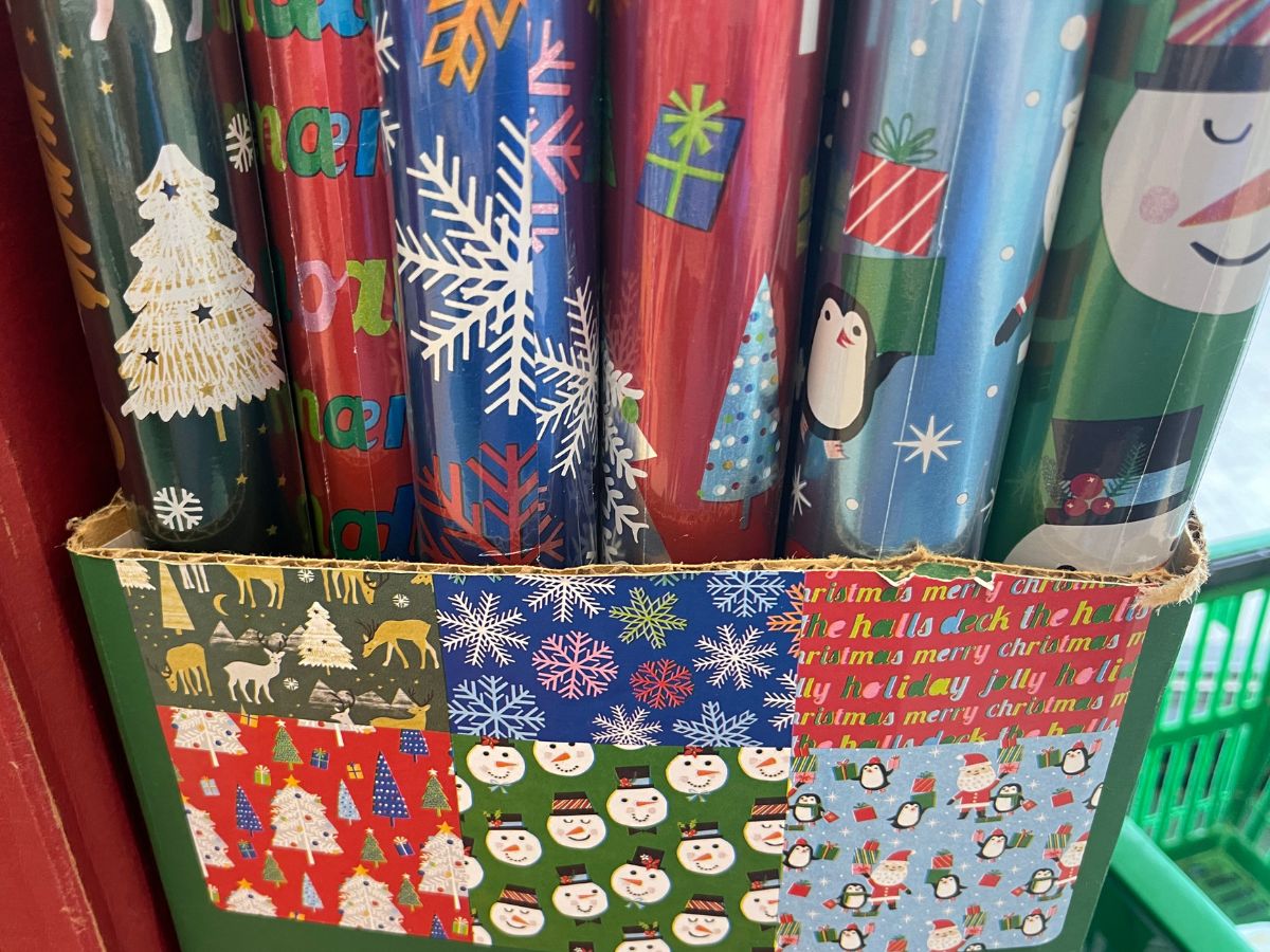 Colorful rolls of christmas gift wrap on display in a store