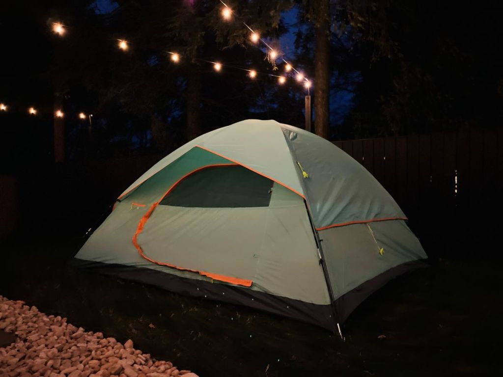 Tent with string lights above it