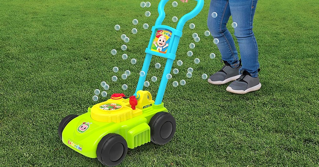 child pushing cocomelon mower with bubbles coming out