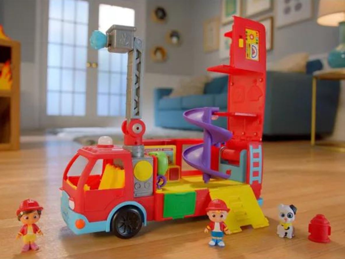 A cocomelon fire truck play set on the floor