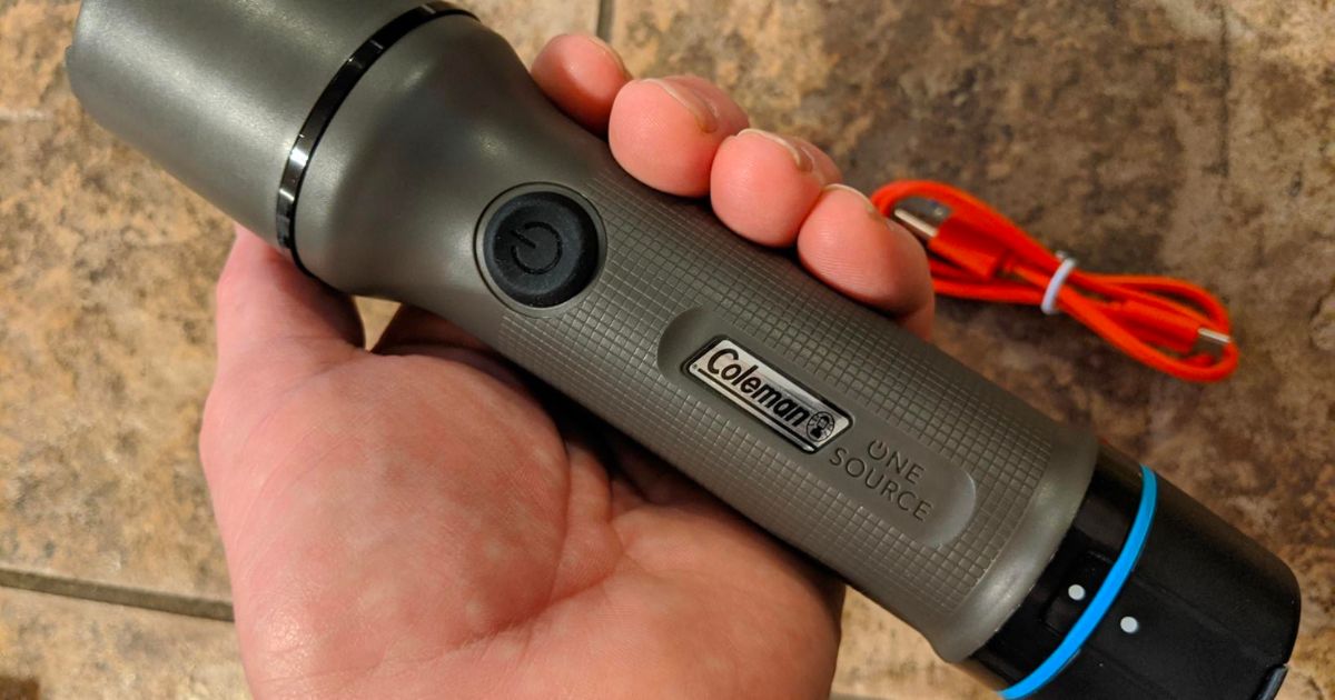 a mans hand holding a Coleman OneSource Water-Resistant Rechargeable LED Flashlight