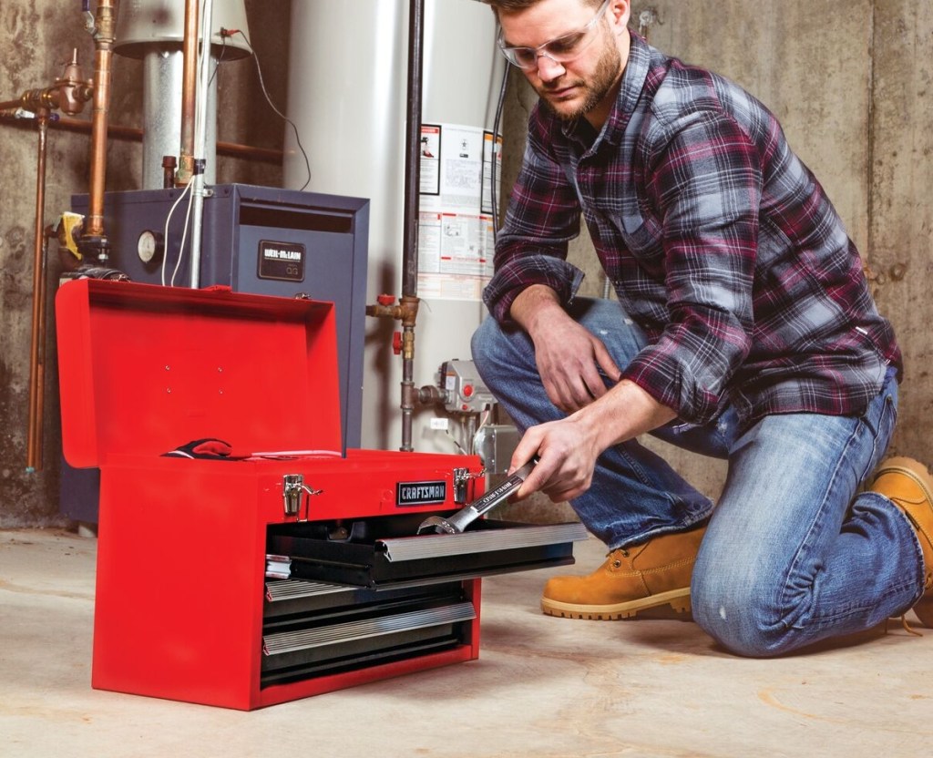 man putting a tool in a Craftsman Tool Box