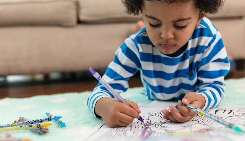 boy coloring with Crayola Twistables