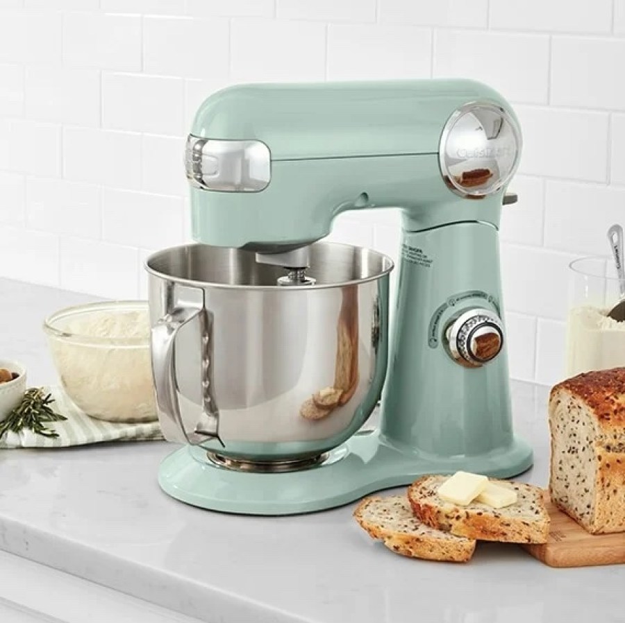 Cuisinart stand Mixer near a bowl, a towel, and a loaf of sliced bread with butter