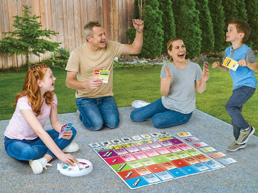 Family outside playing the giant game of life