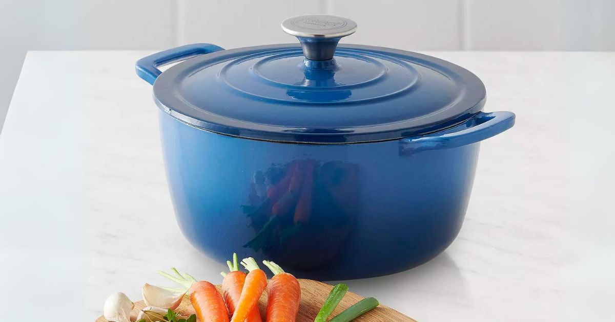 Food Network 5qt Enameled Cast Iron Dutch Oven in blue ombre on a kitchen counter next to fresh carrots