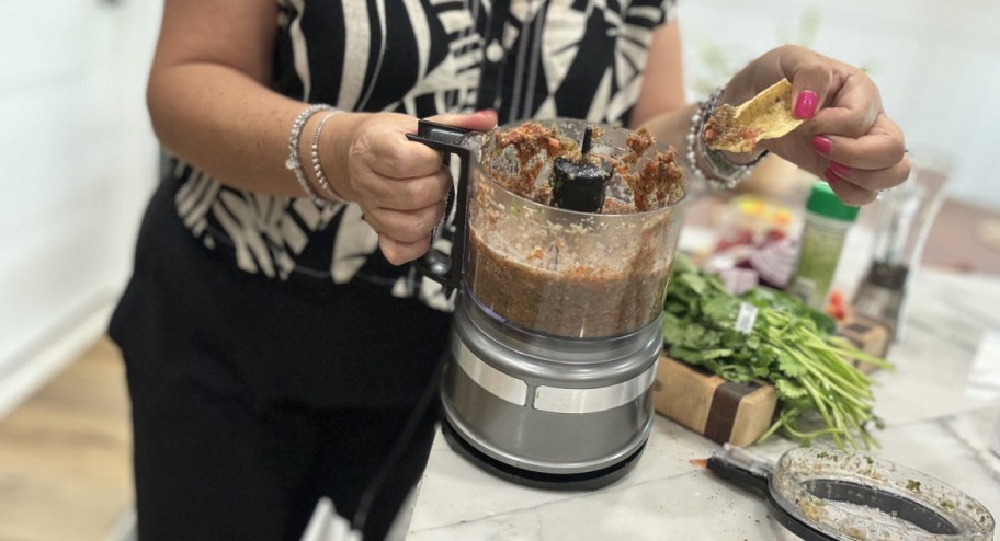 Food chopper being shown off with chips and salsa inside