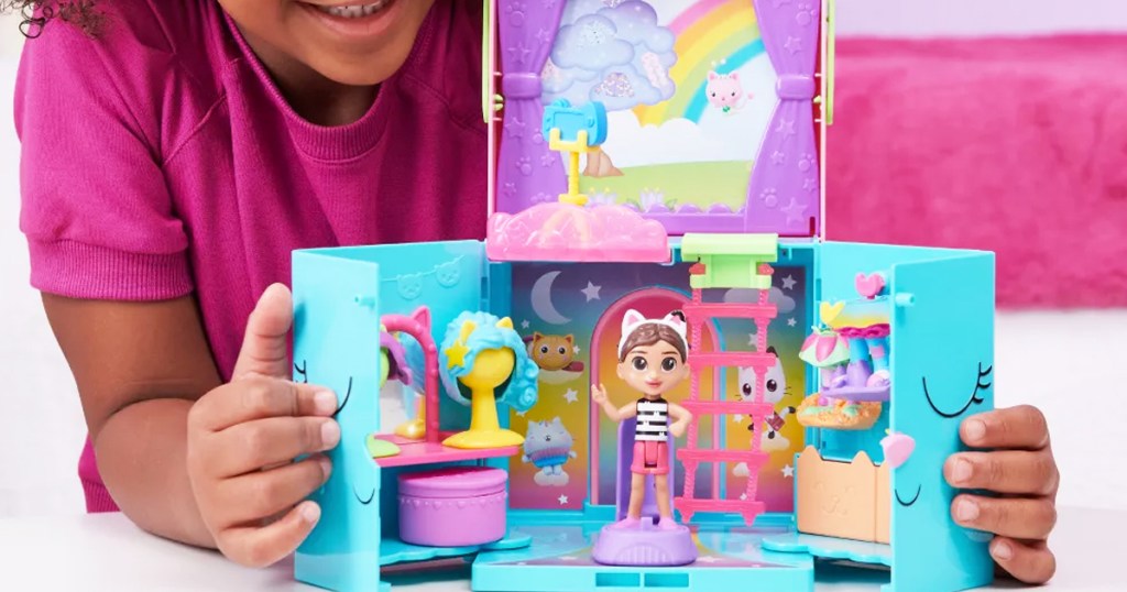girl playing with Gabby's Dollhouse Rainbow Closet Portable Playset