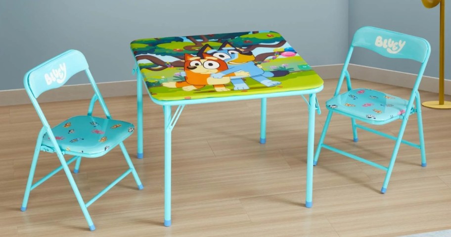 a blue kid size table and chairs set with characters from Bluey on them