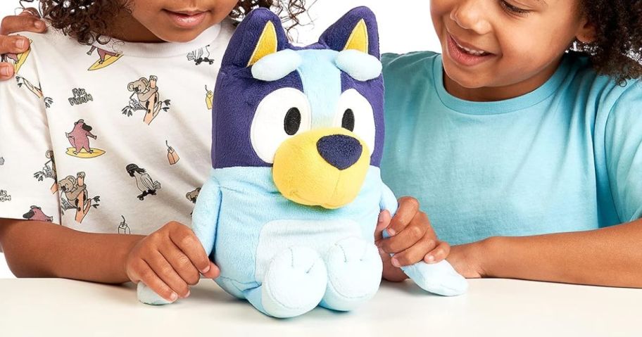 kids playing with a Bluey plush