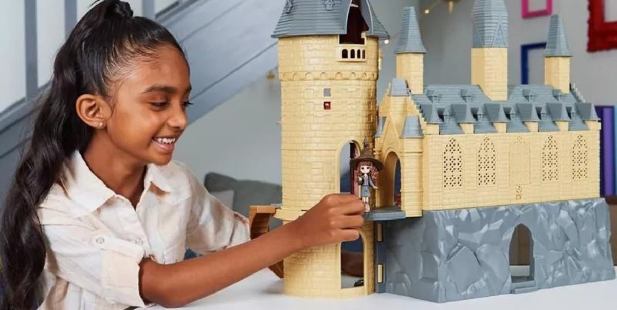 girl playing with mini Hogwarts castle
