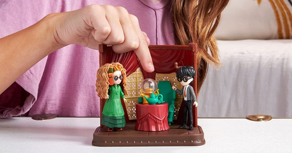 person playing with Harry Potter playset
