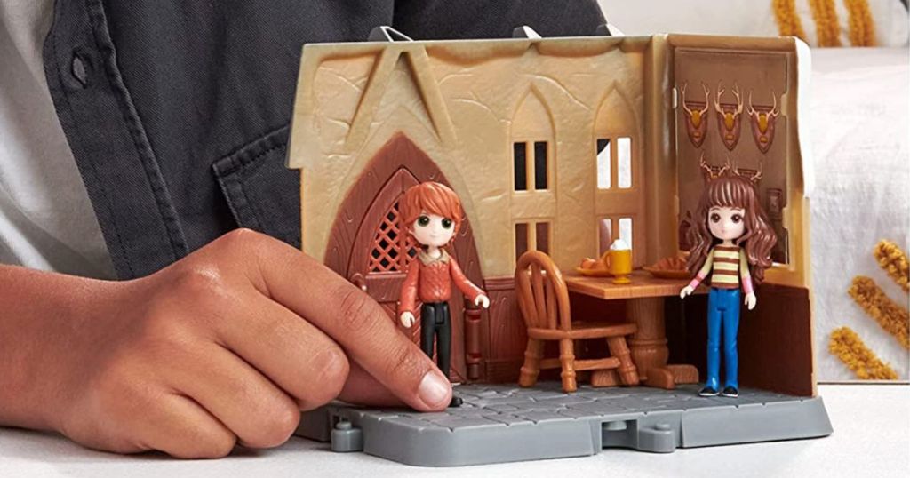 kid playing with Harry Potter playset