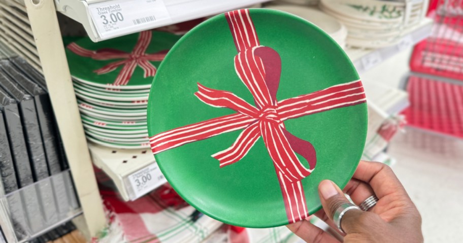 person holding up green holiday plate at target store