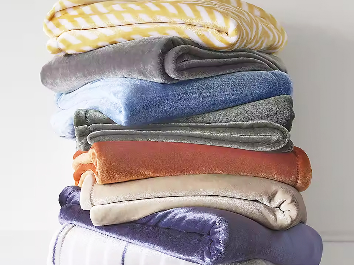 stack of folded velvet throw blankets