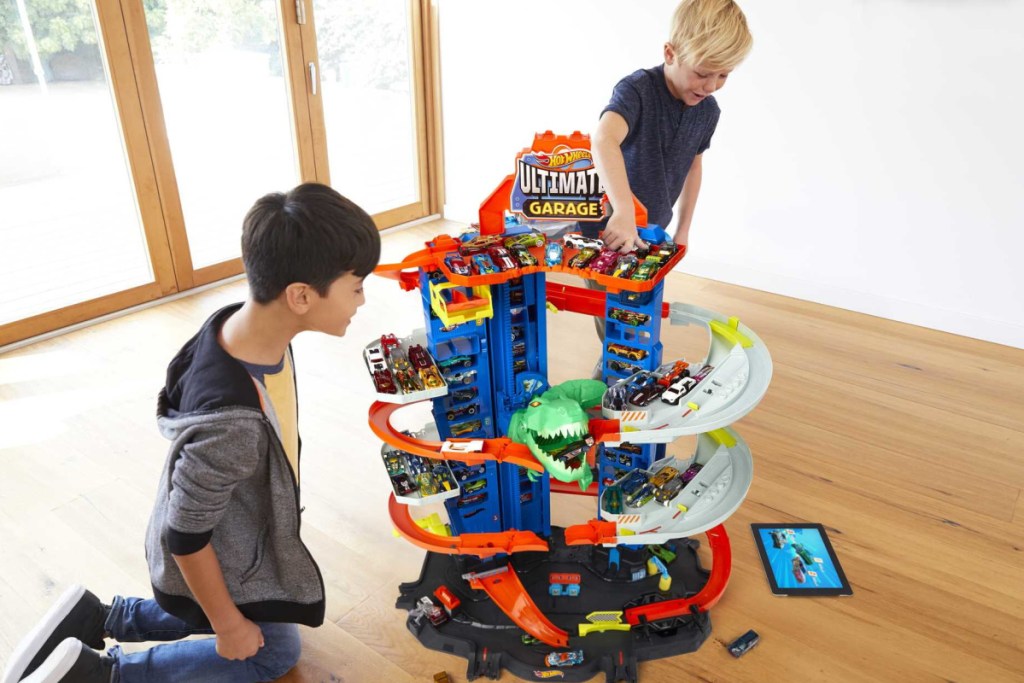boys playing with a Hot Wheels Ultimate Garage
