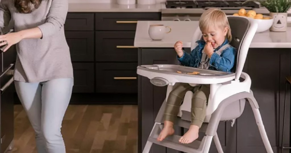 toddler in gray and white high chair
