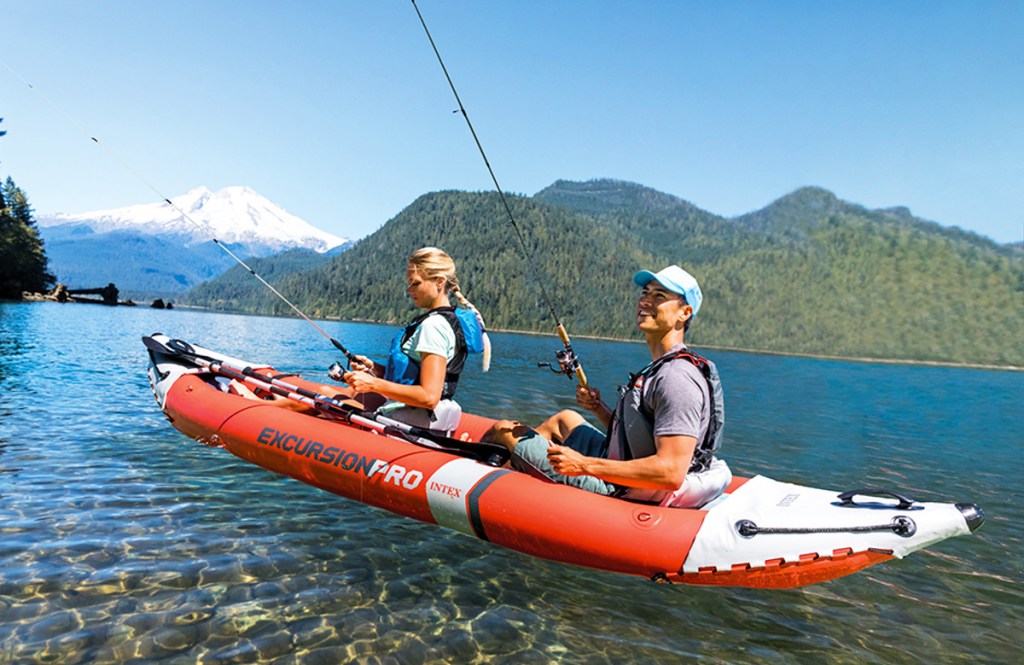 two people fishing from red and white kayak