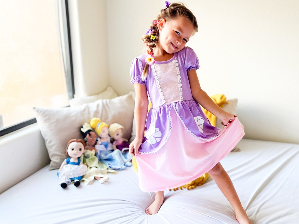 girl wearing pink and purple disney princess dress