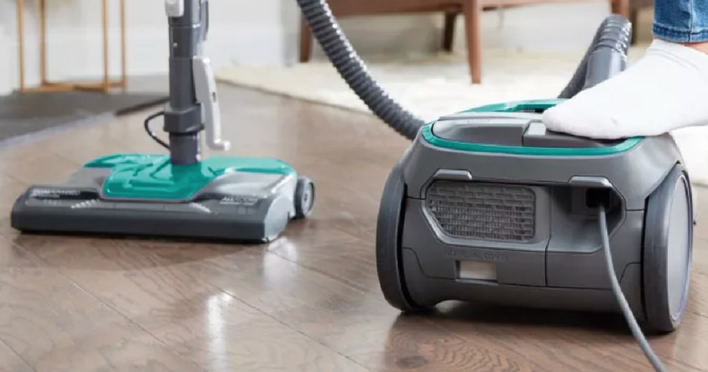 gray and teal bagged vacuum cleaner