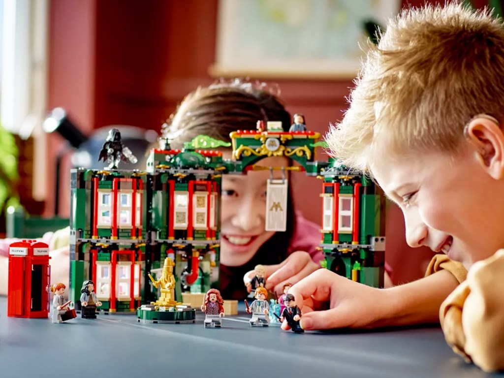 boy and girl playing with harry potter lego set