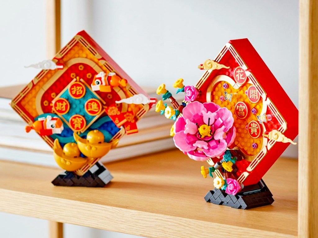two lego lunar new year sets on wood shelf