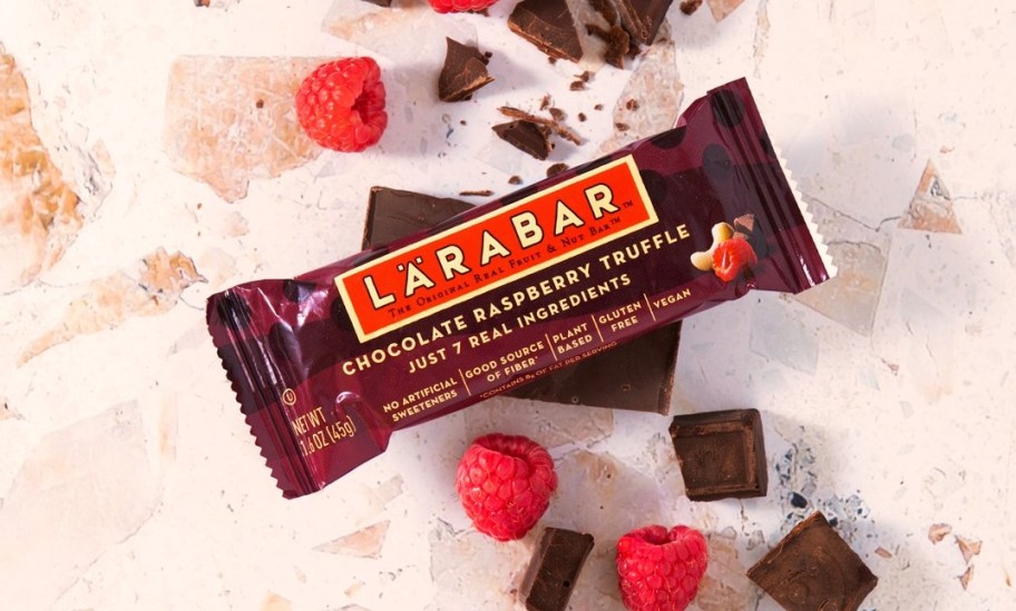 Larabar Chocolate Raspberry Truffle bar with chocolate pieces and raspberries around it