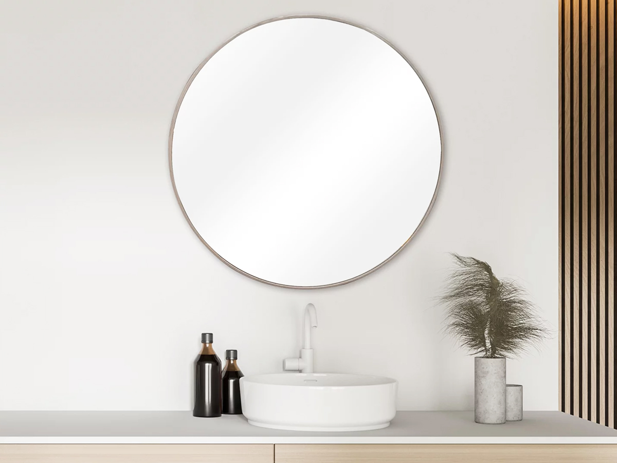 round mirror on bathroom wall