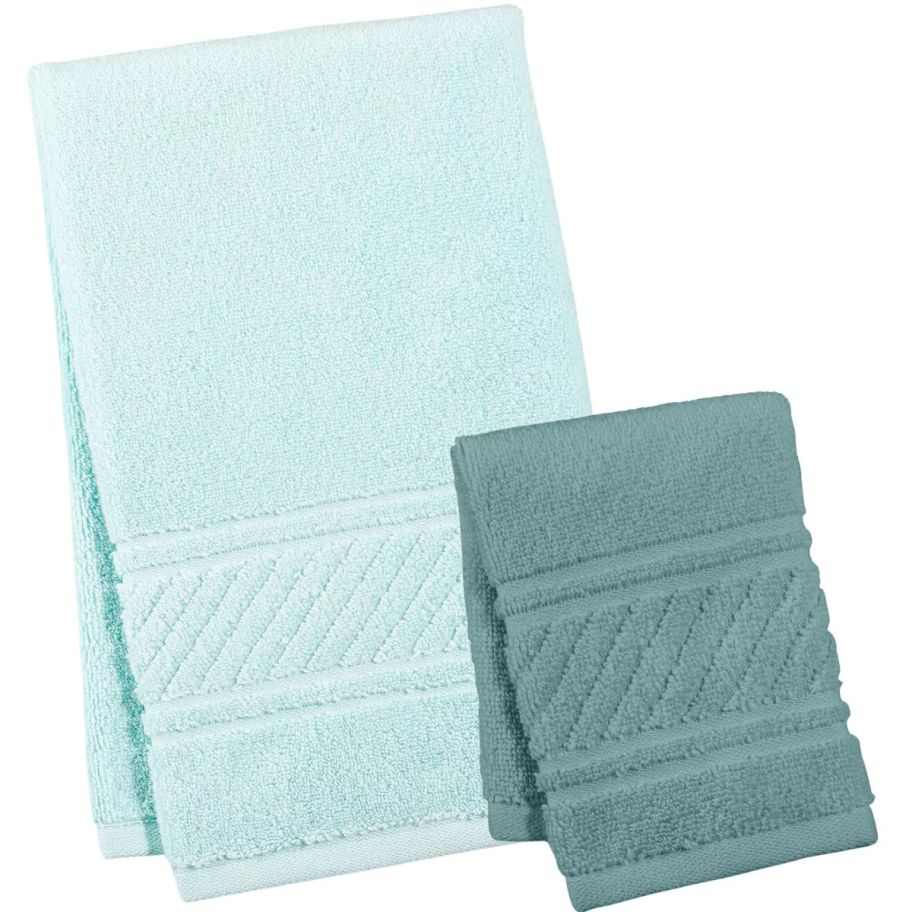 a light green hand towle and a dark green wash cloth