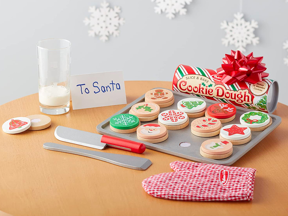 Melissa and Doug Christmas Cookies Play Set displayed on a table with a to santa sign and snowflakes on the wall
