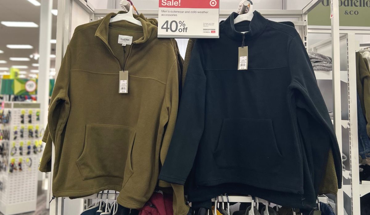 Mens outerwear half zip fleece sweatshirt in navy and olive on a rack in the store