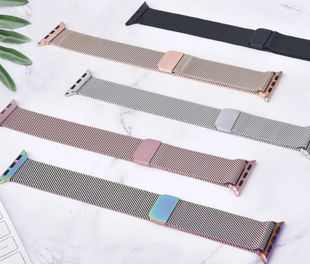 5 mesh apple watch bands laid out on a table