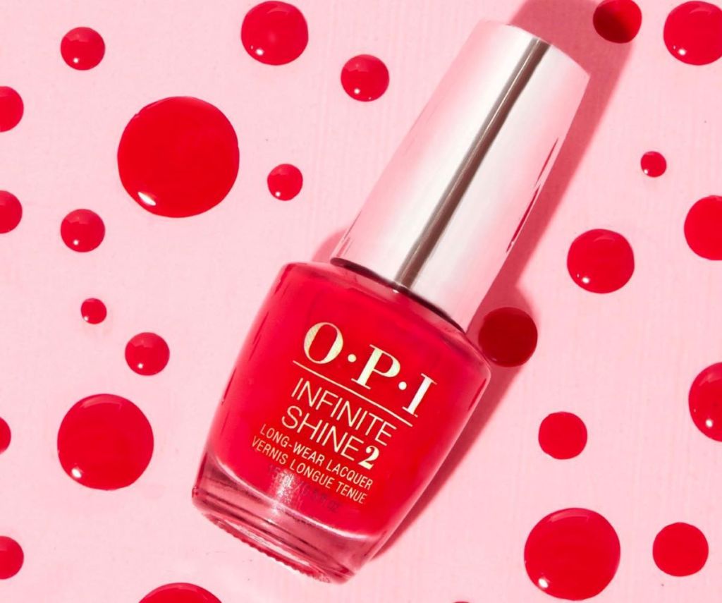 OPI Infinite Shine nail polish with dots of polish behind it