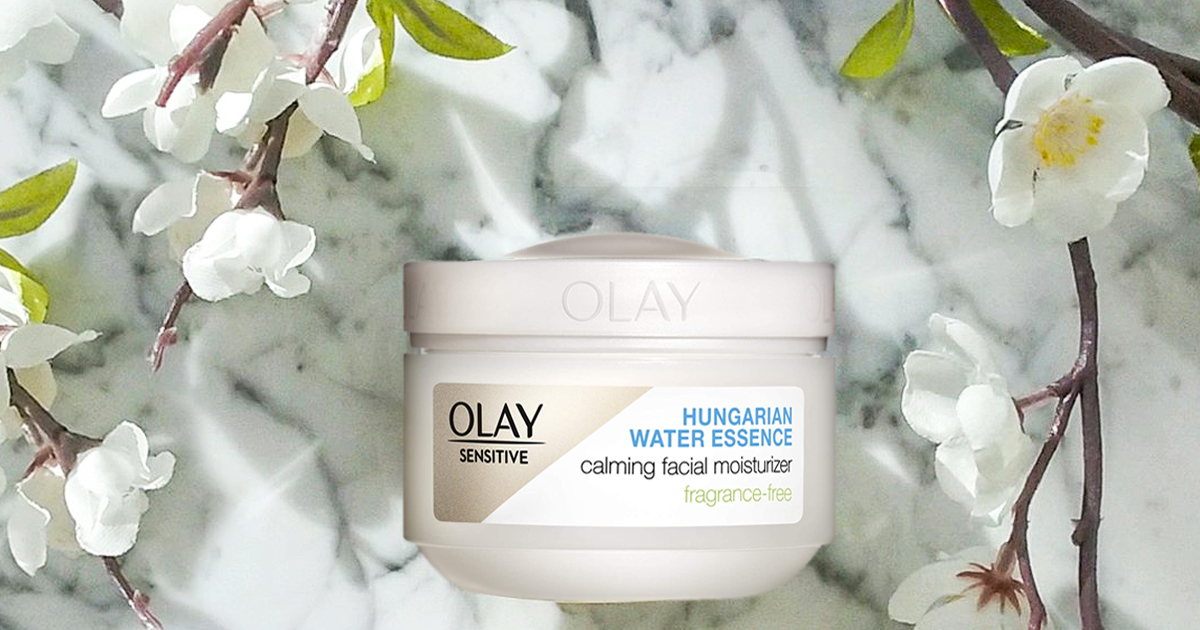 Olay Sensitive Calming Face Moisturizer surrounded by flowers