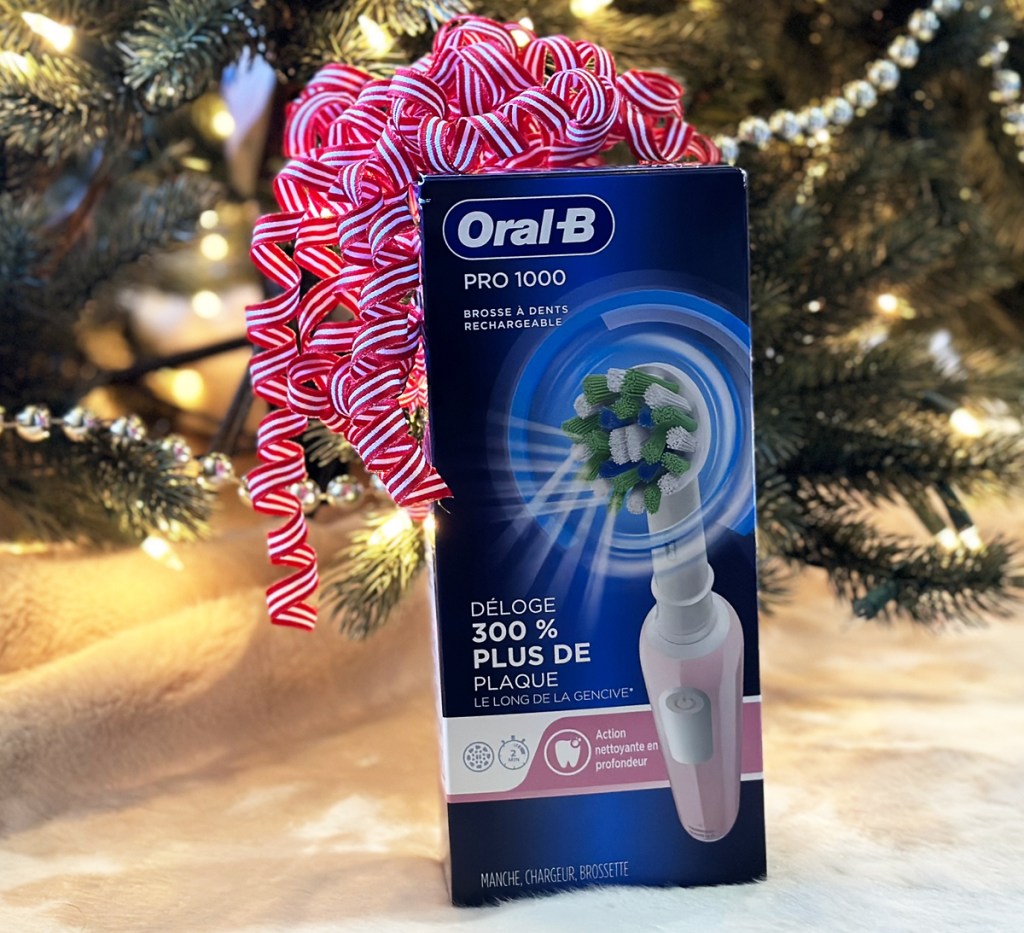bow on top of oral b toothbrush box under christmas tree