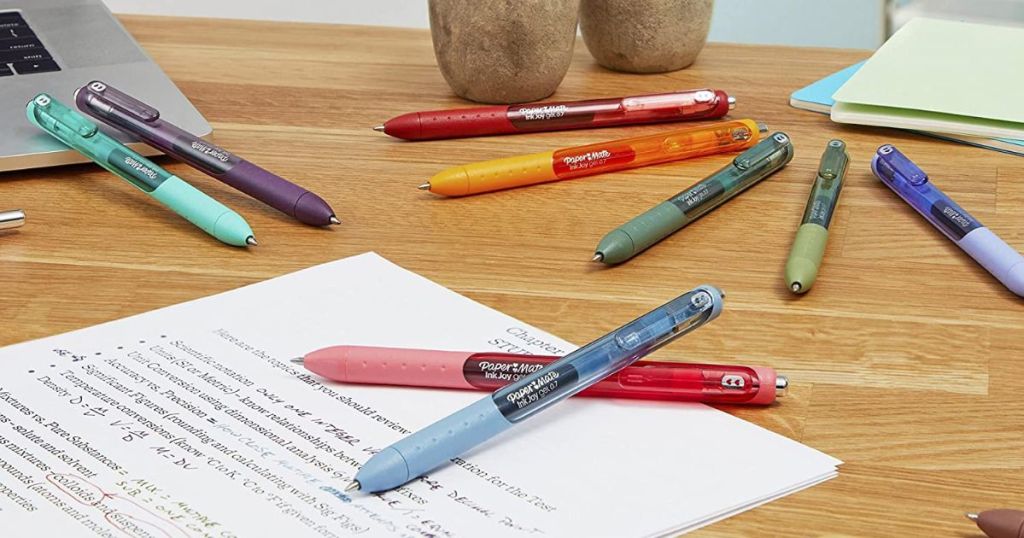 various Paper Mate Inkjoy gel pens laying on desk 