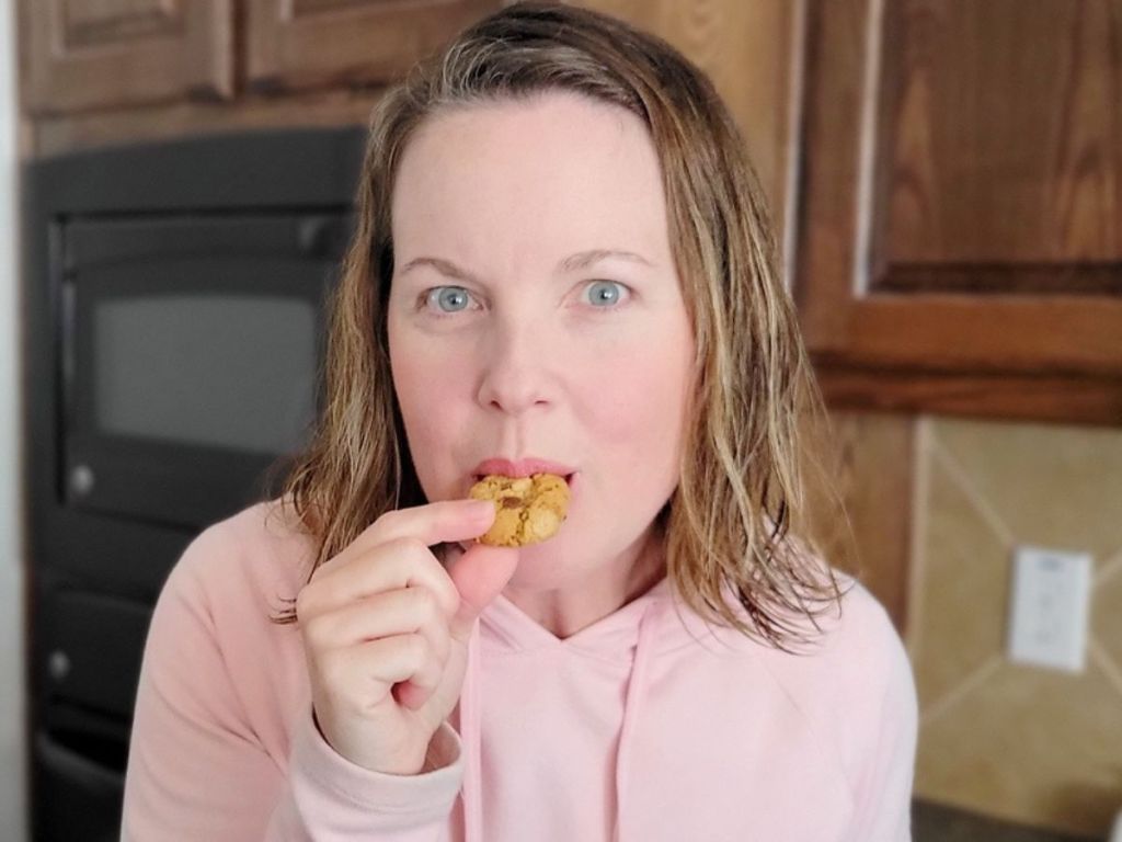 woman eating a small cookie