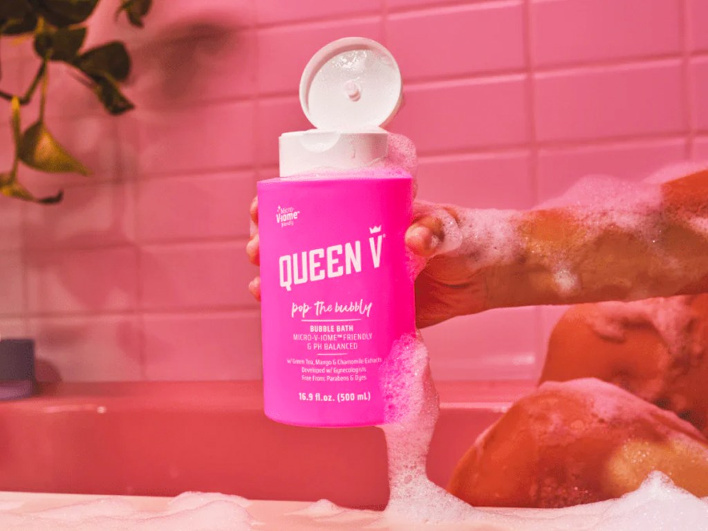holding pink bottle of Queen V Pop The Bubbly Bubble Bath